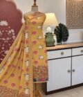 Hand Highlighted Pichwai Mul Cotton Unstitched Salwar Suit by Ikhtirah (Pastel Mustard)